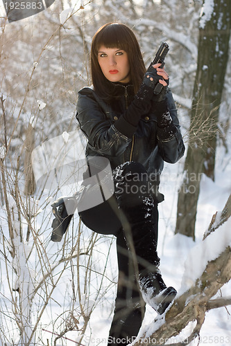 Image of Sexy young woman with a pistol