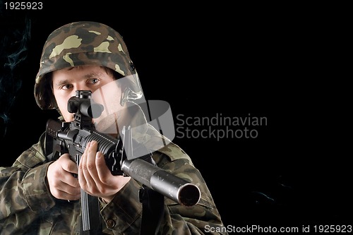 Image of Man keeping a gun in studio