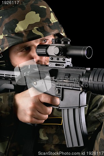 Image of Armed soldier taking aim