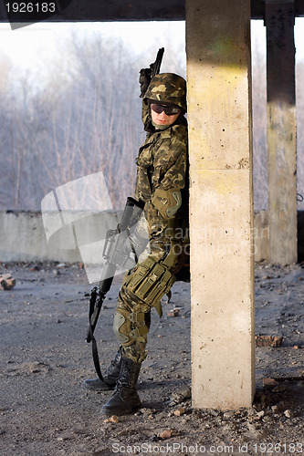 Image of Adult man with rifle and gun