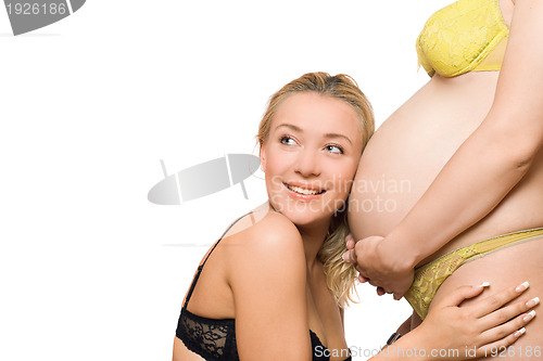 Image of Happy young woman and belly of pregnant girlfriend