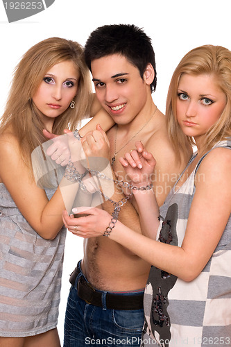 Image of Playful young man and two sad blonde