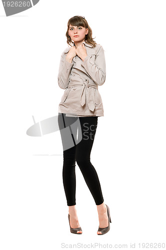 Image of Lovely young woman wearing a coat