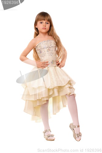 Image of Pretty little girl in a beige dress