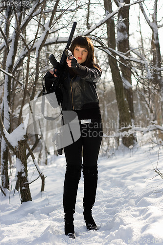 Image of Armed beautiful young woman 
