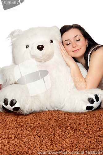Image of Girl asleep leaning against a teddy bear
