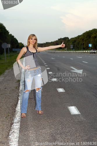 Image of Young woman on the roadside