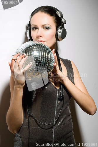 Image of Portrait of nice young brunette in headphones