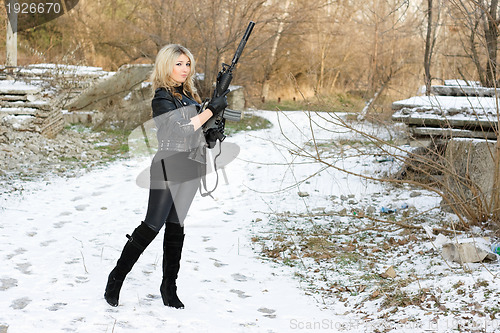 Image of Beautiful young woman with a gun