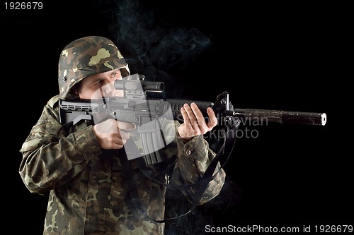 Image of Alerted soldier keeping a smoking gun