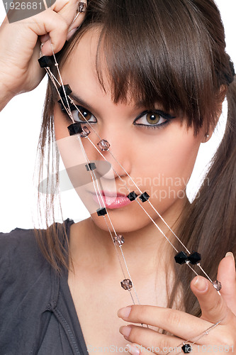 Image of Closeup portrait of pretty brunette with a beads