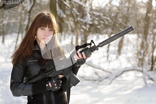 Image of Beautiful armed girl in the forest