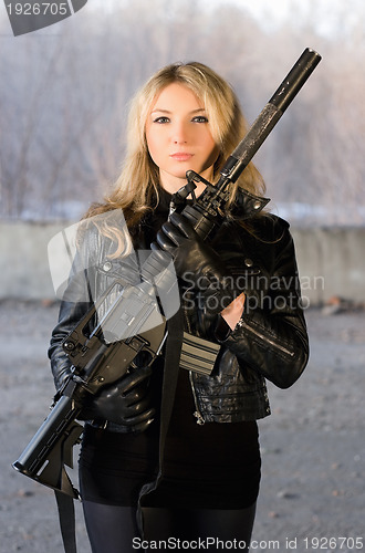 Image of Armed beautiful young woman