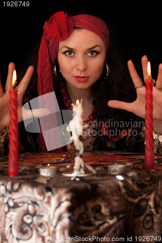 Image of Witch at the table with candles. Isolated 