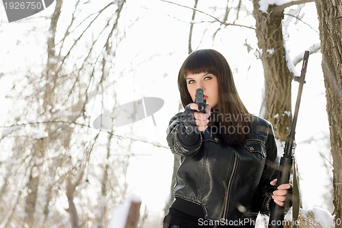 Image of young woman with a pistol