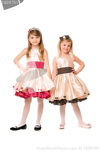 Image of Two beautiful little girls in a dress