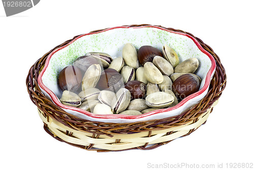 Image of hazelnuts and pistachios in a wicker basket