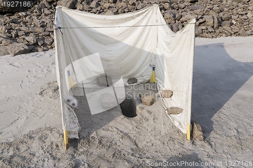 Image of toilet in the sand