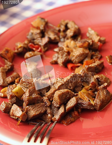 Image of beef on red plate