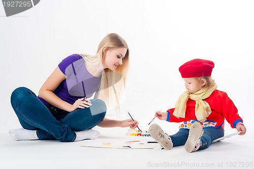 Image of Pretty young mother and daughter drawing