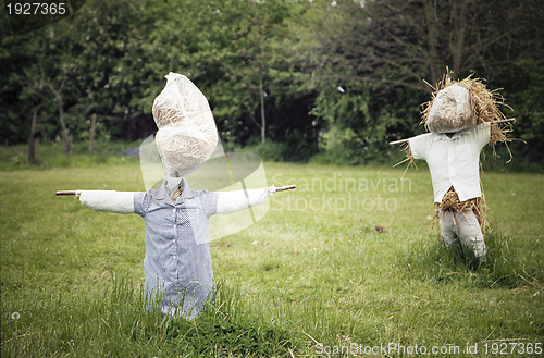 Image of Two straw scarecrows