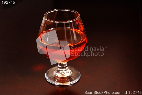 Image of Warming snifter of Amaretto liquor on a table
