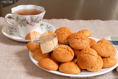 Image of Plate of crisp Italian Amaretti cookies with a cup of hot tea in