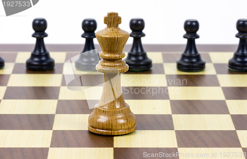 Image of chess king against pawns