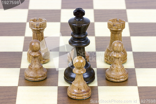 Image of chess king against pawns