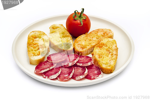 Image of tomato rubbed on a slice of bread