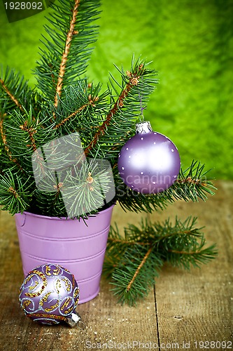 Image of christmas fir tree and purple decorations 