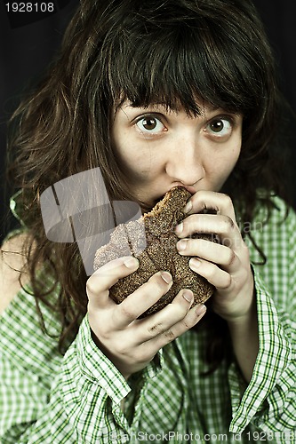 Image of poor beggar woman eating bread