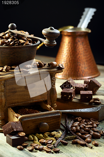 Image of Old coffee grinder and coffee with cardamom.