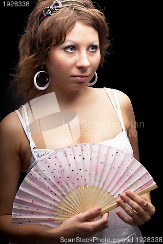 Image of Attractive woman with a fan