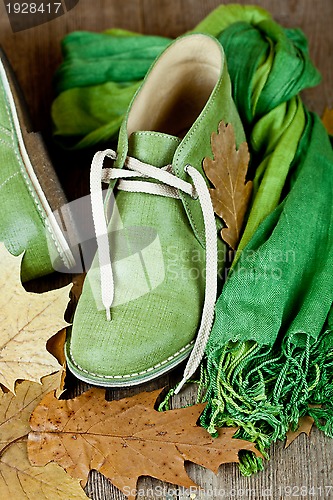 Image of boots, scarf and yellow leaves