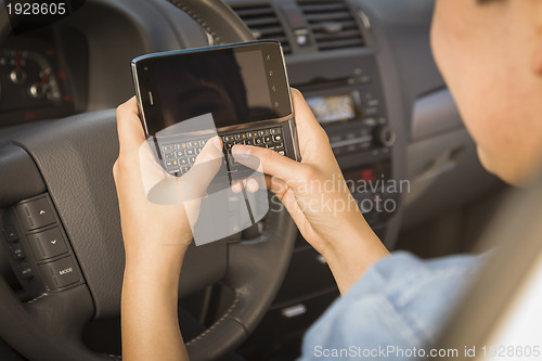 Image of Mixed Race Woman Texting and Driving