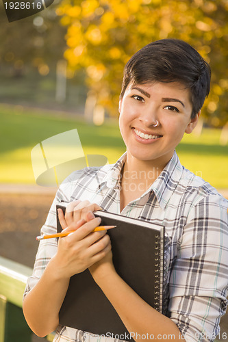 Image of Portrait of a Pretty Mixed Race Female Student Holding Books