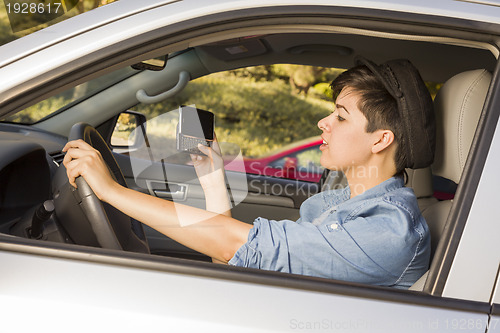 Image of Mixed Race Woman Texting and Driving