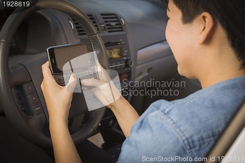 Image of Mixed Race Woman Texting and Driving