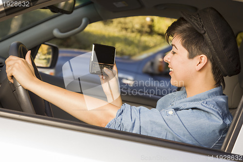 Image of Mixed Race Woman Texting and Driving