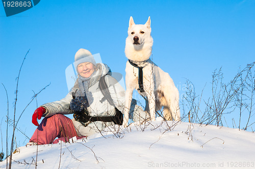 Image of The woman with a dog in winter on walk