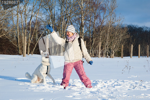 Image of The woman with a dog in winter on walk
