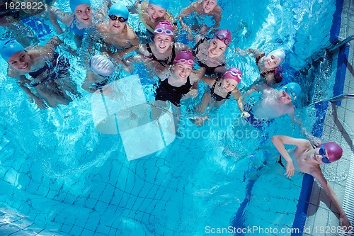 Image of happy children group  at swimming pool