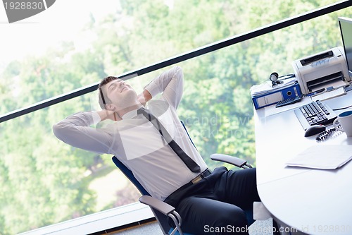 Image of happy young business man at office