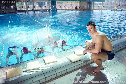 Image of happy children group  at swimming pool