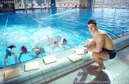 Image of happy children group  at swimming pool