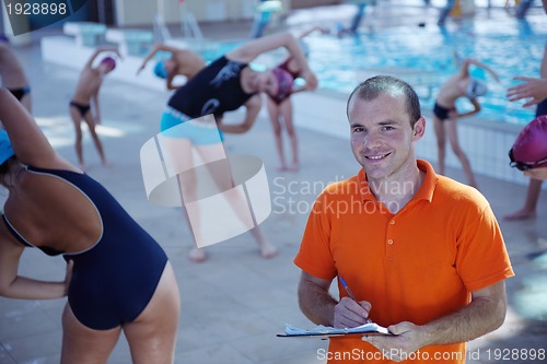Image of happy children group  at swimming pool