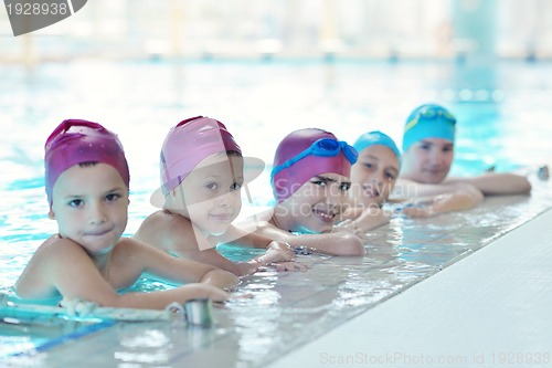 Image of happy children group  at swimming pool