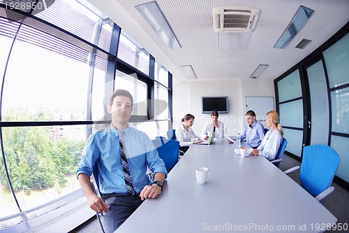 Image of business man  on a meeting in offce with colleagues in backgroun