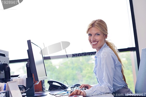 Image of business woman working on her desk in an office